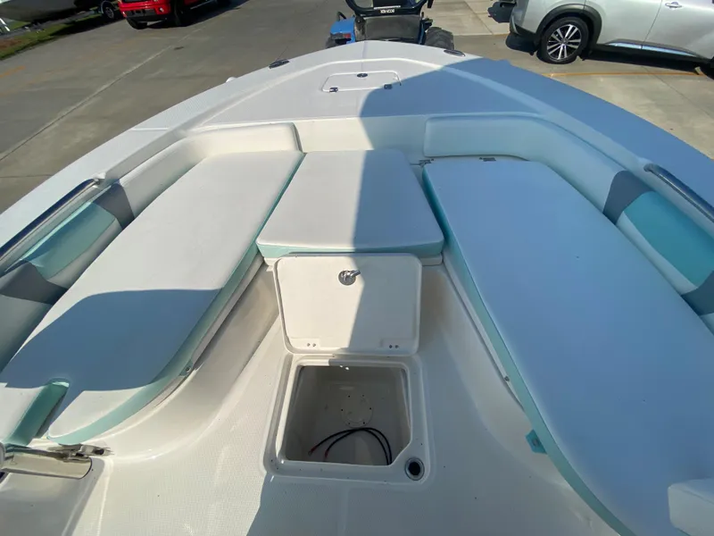 Slide: The Image of 2024 Robalo 226 Cayman boat interior with seating and storage compartments. - 23