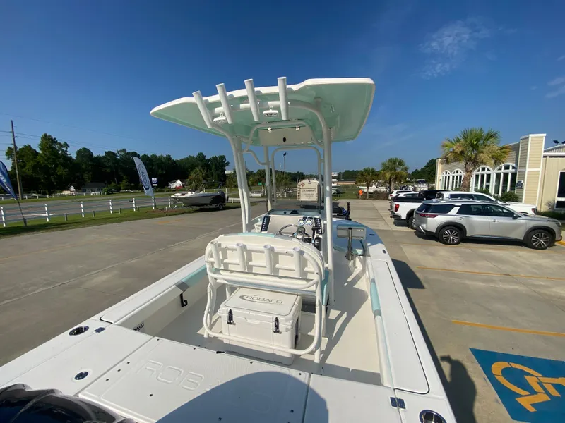 Slide: The Image of 2024 Robalo 226 Cayman boat in a parking lot, rear view. - 6