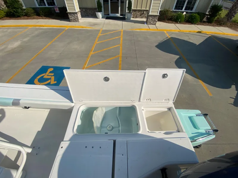 Slide: The Image of 2024 Robalo 226 Cayman boat with open storage compartments, viewed from above. - 8