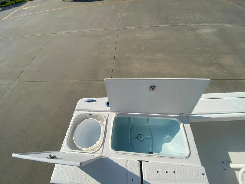 Slide: The Image of 2024 Robalo 226 Cayman boat with open storage compartments. - 9