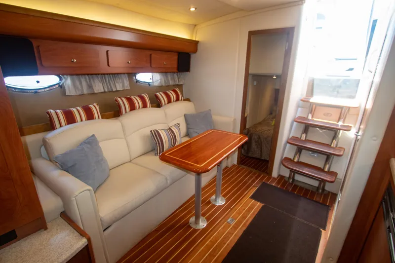 Slide: The Image of Interior of 2008 Rinker 400 Express Cruiser with sofa, table, and stairs. - 12