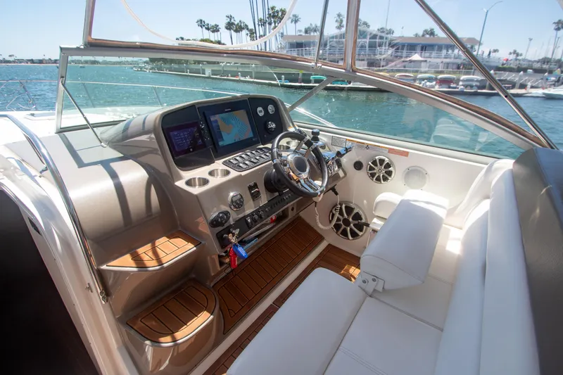 Slide: The Image of 2008 Rinker 400 Express Cruiser helm with navigation screens and white seating. - 2