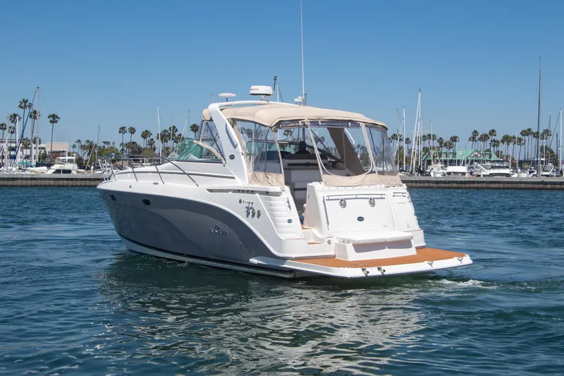 Slide: The Image of 2008 Rinker 400 Express Cruiser on calm waters with marina background. - 22
