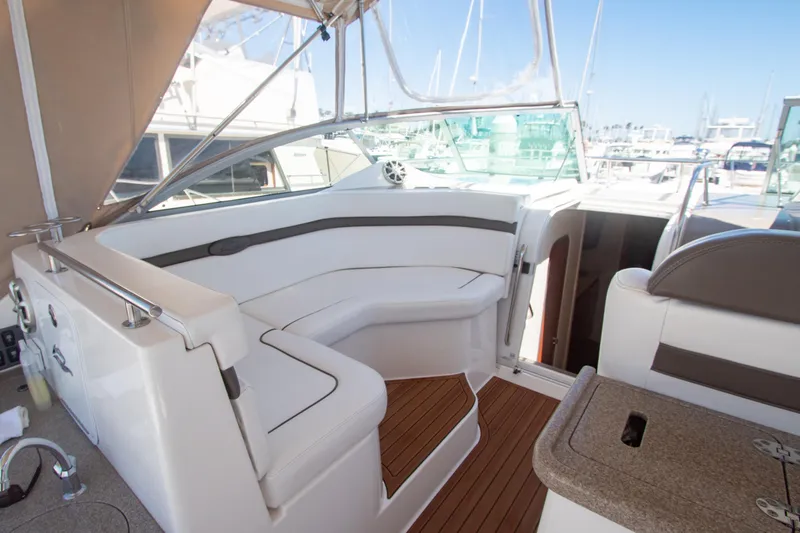 Slide: The Image of 2008 Rinker 400 Express Cruiser interior seating area with white upholstery and wooden flooring. - 3