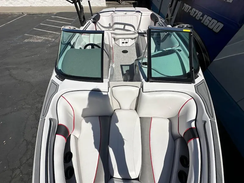 Slide: The Image of 2024 Sanger V237 S boat interior with white and gray seating, open windshield. - 14