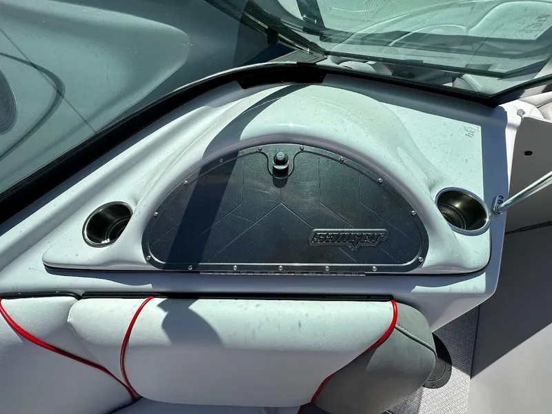 Slide: The Image of 2024 Sanger V237 S boat dashboard with glove compartment and cup holders. - 21