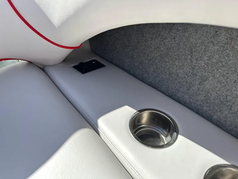 Slide: The Image of 2024 Sanger V237 S boat interior with cup holders and storage compartment. - 26