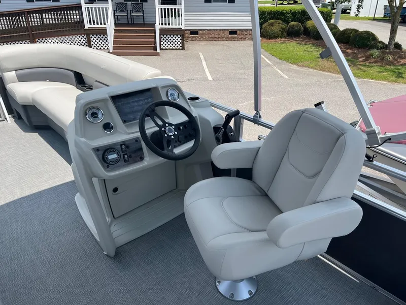 Slide: The Image of 2024 Starcraft LX22 F boat interior with captain's chair and control console. - 11