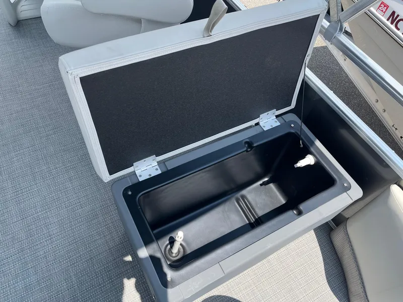 Slide: The Image of 2024 Starcraft LX22 F boat storage compartment with open lid. - 5