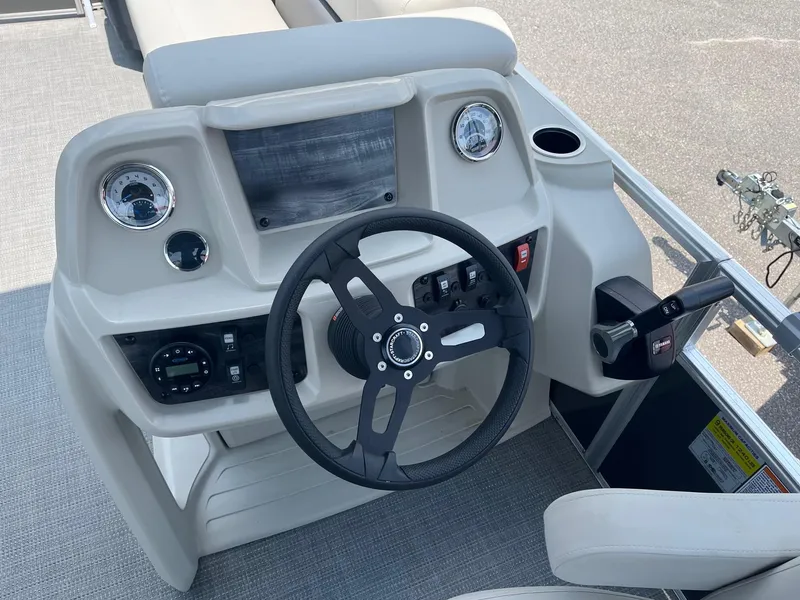 Slide: The Image of 2024 Starcraft LX22 F boat dashboard with steering wheel and controls. - 10