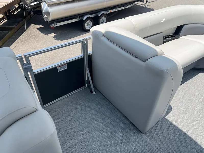 Slide: The Image of 2024 Starcraft LX22 F pontoon boat interior with gray seating and flooring. - 14