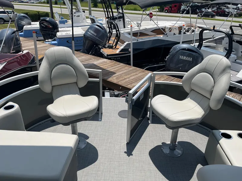 Slide: The Image of 2024 Starcraft LX22 F boat interior with two swivel seats at the dock. - 6