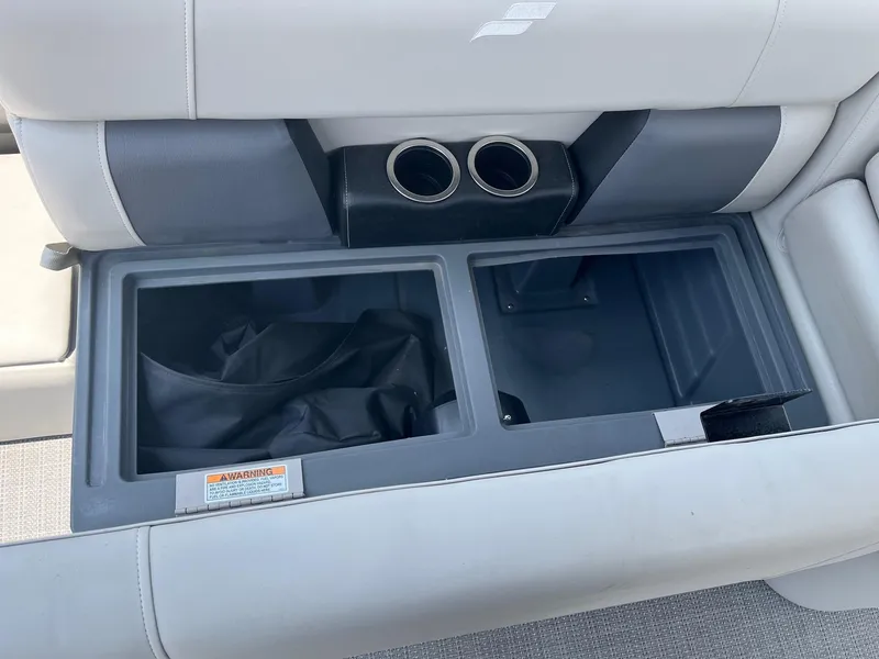 Slide: The Image of 2024 Starcraft LX22 F boat storage compartment with cup holders. - 8