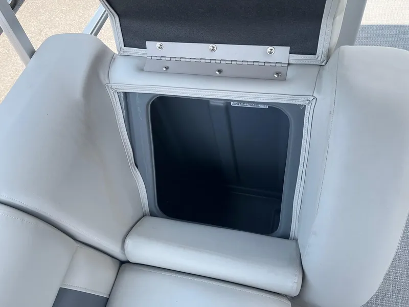 Slide: The Image of 2024 Starcraft LX22 F boat storage compartment with open lid. - 9