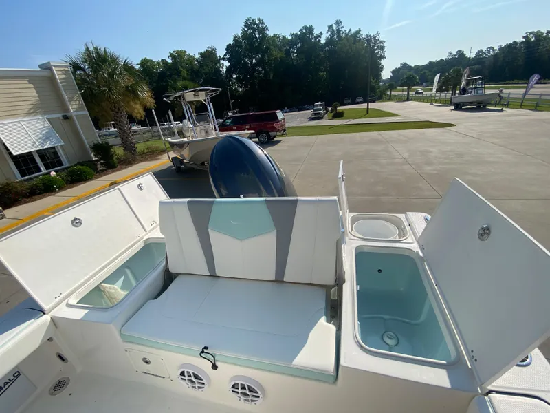 Slide: The Image of 2024 Robalo 226 Cayman boat interior with open storage compartments. - 10