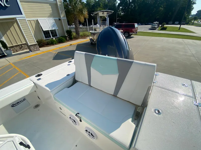 Slide: The Image of 2024 Robalo 226 Cayman boat interior with seating and outboard motor. - 11