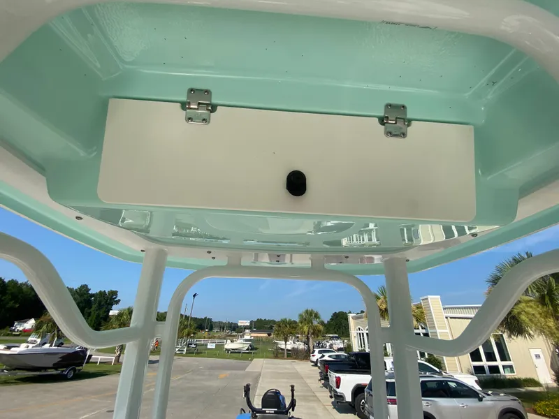 Slide: The Image of 2024 Robalo 226 Cayman boat T-top storage compartment. - 18