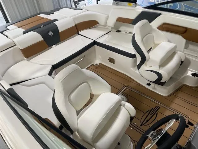 Slide: The Image of 2025 Chaparral 23 Surf boat interior with white and brown seating, modern design. - 12