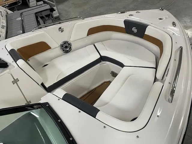 Slide: The Image of 2025 Chaparral 23 Surf boat interior with white and brown seating. - 13