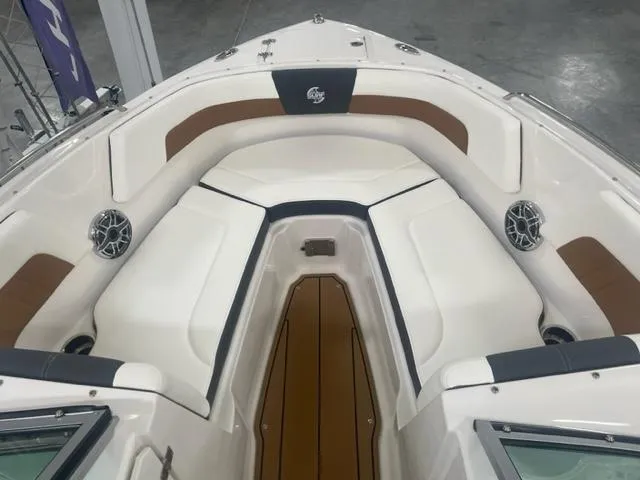 Slide: The Image of 2023 Chaparral 23 Surf boat interior with white and brown seating. - 14