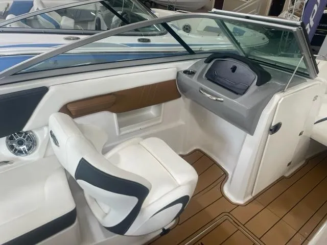Slide: The Image of 2023 Chaparral 23 Surf boat interior with captain's chair and dashboard. - 3
