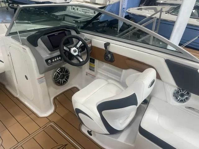 Slide: The Image of 2023 Chaparral 23 Surf boat interior with captain's chair and dashboard. - 4