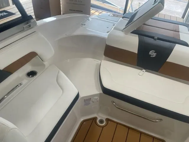 Slide: The Image of 2023 Chaparral 23 Surf boat interior with white and brown seating. - 5