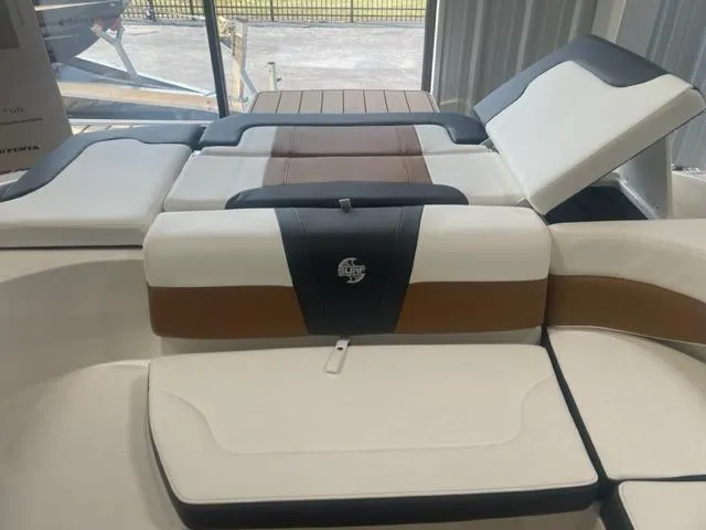 Slide: The Image of 2023 Chaparral 23 Surf boat interior with cushioned seating and storage compartments. - 7