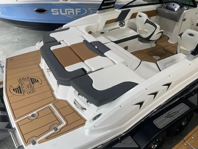 Slide: The Image of 2025 Chaparral 23 Surf boat with sleek interior and stylish deck design. - 9