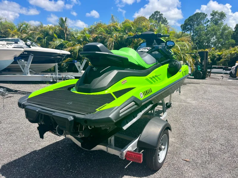 Slide: The Image of 2021 Yamaha WaveRunner VX Cruiser in green on a trailer, parked outdoors. - 5