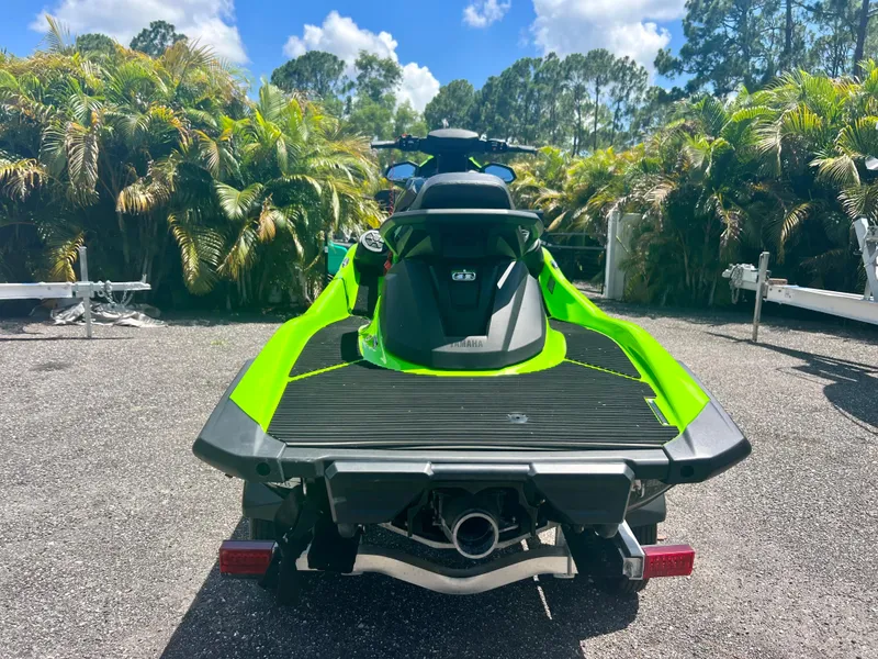 Slide: The Image of 2021 Yamaha WaveRunner VX Cruiser in green, rear view, parked outdoors. - 6