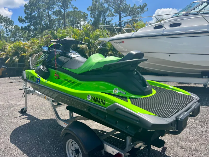 Slide: The Image of 2021 Yamaha WaveRunner VX Cruiser in green on a trailer, parked outdoors. - 7