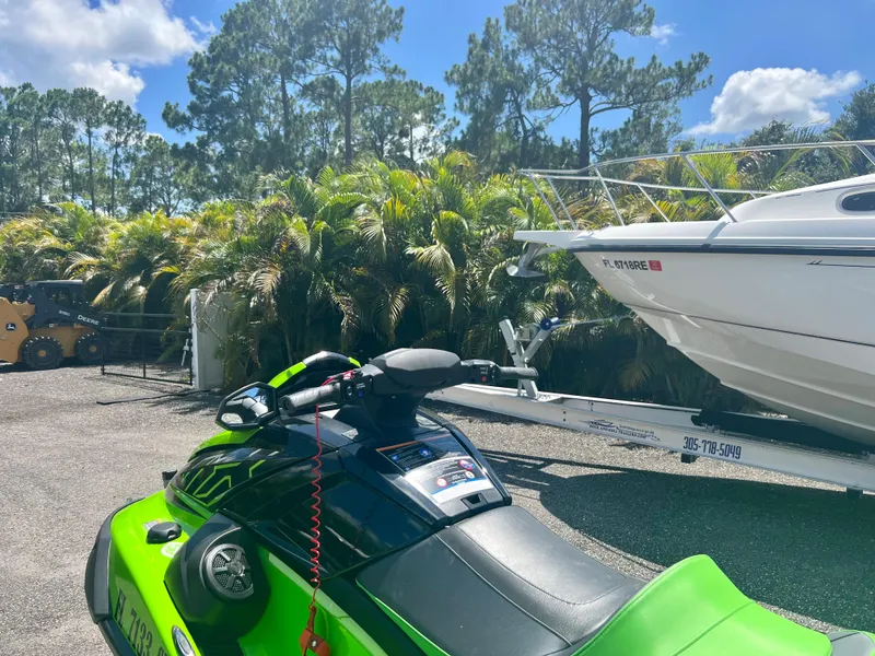 Slide: The Image of 2021 Yamaha WaveRunner VX Cruiser in a tropical setting with a boat in the background. - 8