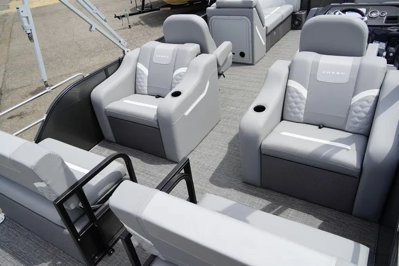Slide: The Image of 2024 Crest Classic DLX 220 SLRC pontoon boat interior with luxurious seating. - 11