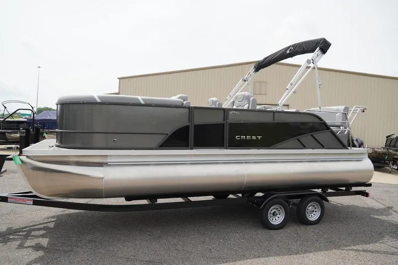 Slide: The Image of 2024 Crest Classic DLX 220 SLRC pontoon boat on a trailer. - 3