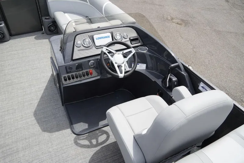 Slide: The Image of 2024 Crest Classic DLX 220 SLRC boat cockpit with steering wheel and control panel. - 7