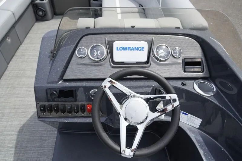 Slide: The Image of 2024 Crest Classic DLX 220 SLRC boat dashboard with Lowrance display and modern controls. - 8