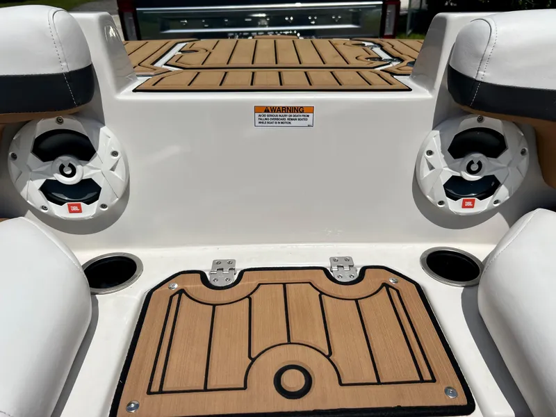 Slide: The Image of 2021 Starcraft 211 SVX boat interior with teak flooring and JBL speakers. - 11