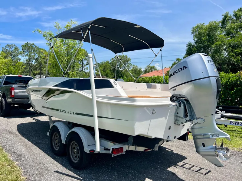 Slide: The Image of 2021 Starcraft 211 SVX boat with Honda outboard motor on trailer. - 14