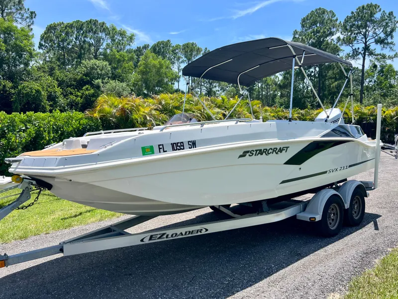 Slide: The Image of 2021 Starcraft 211 SVX boat on EZ Loader trailer with canopy. - 2