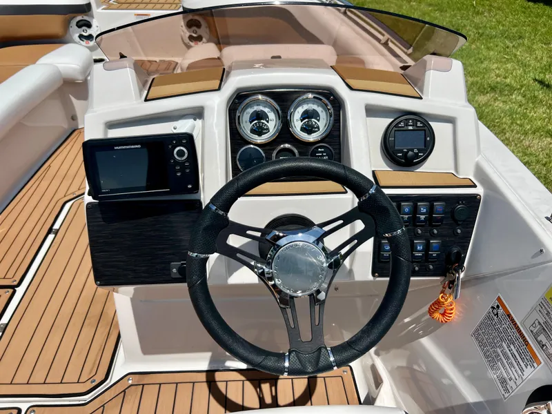 Slide: The Image of 2021 Starcraft 211 SVX boat dashboard with steering wheel and control panel. - 8