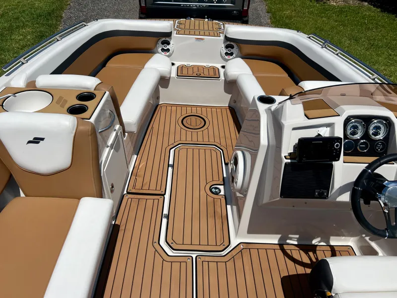 Slide: The Image of 2021 Starcraft 211 SVX boat interior with tan and white seating and modern dashboard. - 9