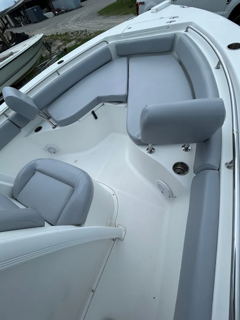 Slide: The Image of 2019 Sea Hunt 225 Ultra boat interior with gray seating and white deck. - 13