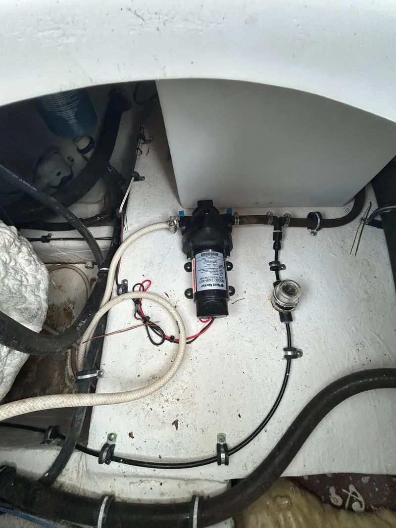 Slide: The Image of 2019 Sea Hunt 225 Ultra boat interior showing pump and wiring setup. - 15