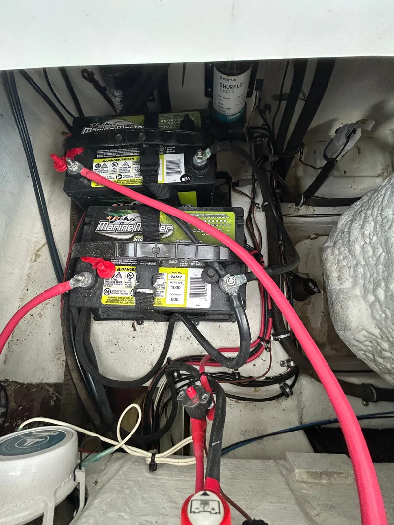 Slide: The Image of Marine batteries and wiring inside a 2019 Sea Hunt 225 Ultra boat. - 17