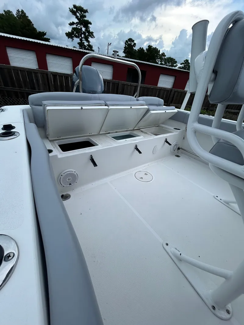 Slide: The Image of 2019 Sea Hunt 225 Ultra boat interior with seating and storage compartments. - 18