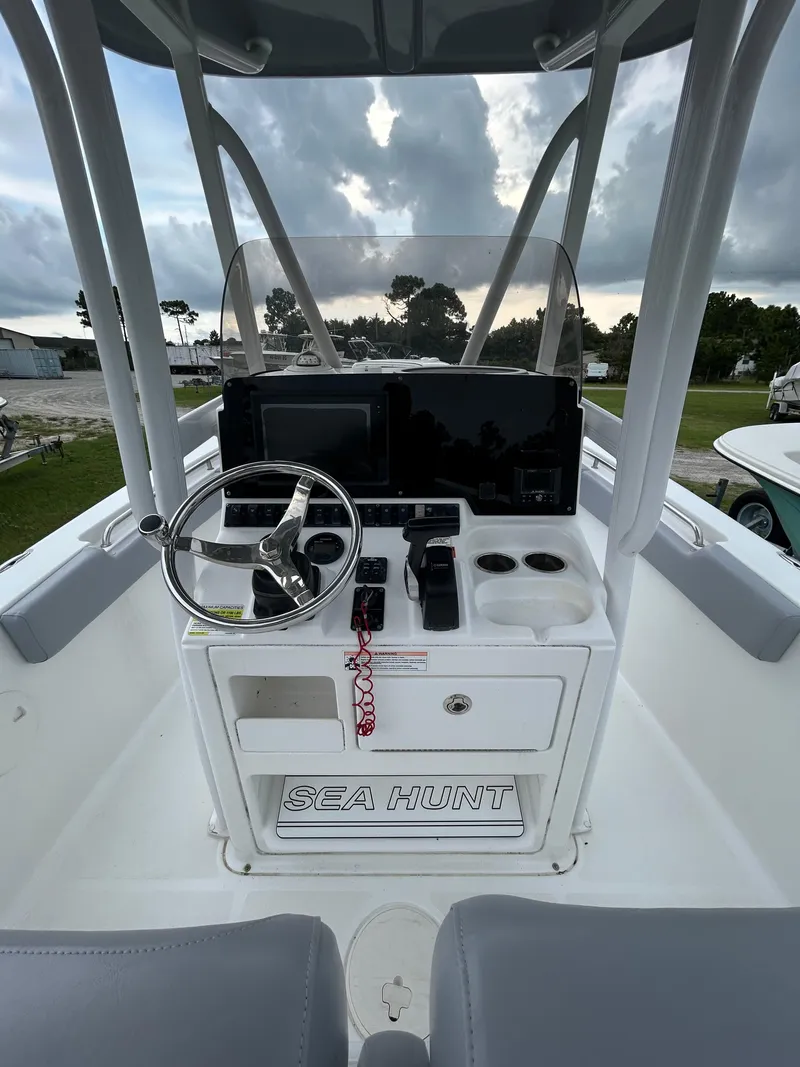 Slide: The Image of 2019 Sea Hunt 225 Ultra boat console with steering wheel and controls. - 21