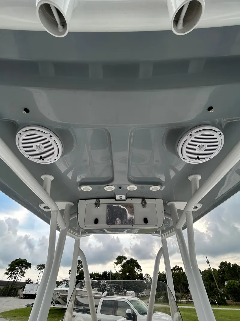 Slide: The Image of 2019 Sea Hunt 225 Ultra boat T-top with speakers and rod holders. - 26