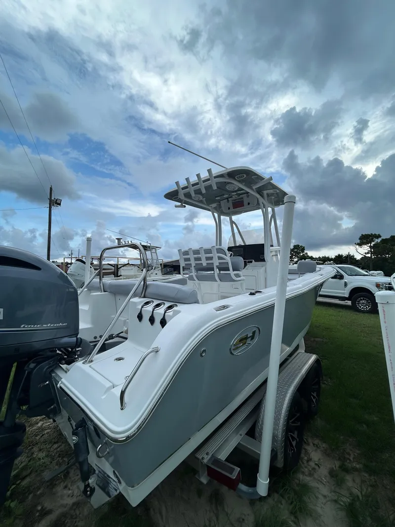Slide: The Image of 2019 Sea Hunt 225 Ultra boat on trailer under cloudy sky. - 9