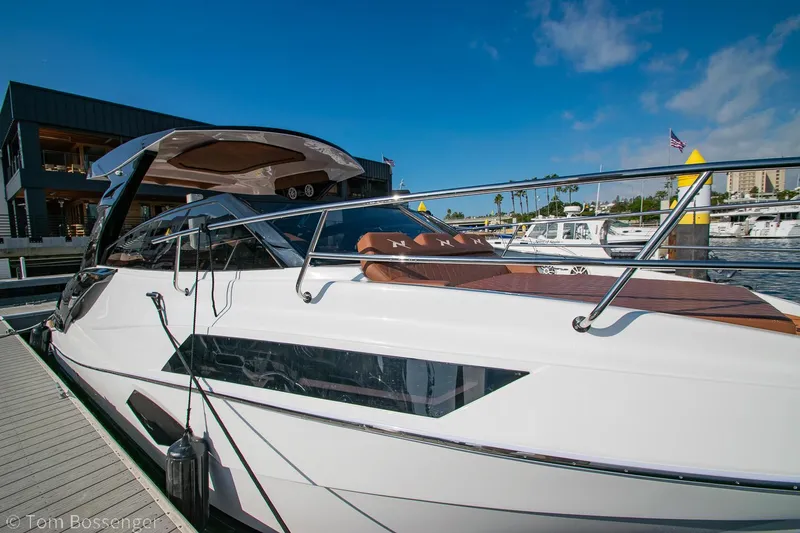 Slide: The Image of 2023 NX Boats 340 Sport Coupe docked, showcasing sleek design and modern features. - 0